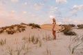 Surfer girl with surfboard on beach and warm sunset colors. Attractive surfer women on beach Royalty Free Stock Photo