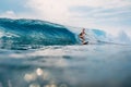 Surfer girl at surfboard on wave in tropical ocean. Sporty woman during surfing Royalty Free Stock Photo