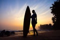 Surfer girl surfing looking at ocean beach sunset. Silhouette w Royalty Free Stock Photo