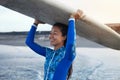 Surfer Girl. Surfing Woman Holding White Surfboard On Head. Smiling Brunette In Blue Wetsuit Going To Surf In Ocean.