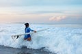 Surfer Girl. Surfing Woman With Surfboard Going To Surf In Ocean. Brunette In Blue Wetsuit Walking Into Splashing Sea.