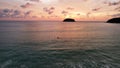 A surfer girl is waiting for a wave at sunset. Royalty Free Stock Photo