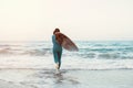 Surfer girl walking with board on the sandy beach. Surfer female.Beautiful young woman at the beach. water sports. Healthy Active Royalty Free Stock Photo