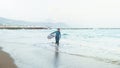 Surfer girl walking with board on the sandy beach. Surfer female.Beautiful young woman at the beach. water sports. Healthy Active Royalty Free Stock Photo