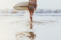 Surfer girl walking with board on the sandy beach. Royalty Free Stock Photo