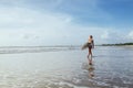 Surfer girl walking with board on the sandy beach. Royalty Free Stock Photo