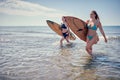 Surfer girl walking with board. Surfer girl. Beautiful young woman at the beach. water sports. Surfing. Summer Vacation. . Royalty Free Stock Photo