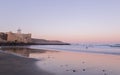 Surfer going to the water in Las Canteras beach, la cicer at sunrise in Las Palmas de Gran Canaria, Canary islands, Spain.