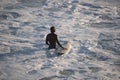 Surfer going into the water to catch waves in Cadiz, Spain Royalty Free Stock Photo