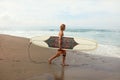 Surfer. Handsome Surfing Man With White Surfboard Walking On Sandy Beach.