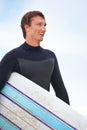 Surfer, happy man on beach and surfboard, vacation and adventure for fitness and travel outdoor. Ocean, waves for Royalty Free Stock Photo