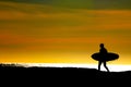 Surfer heading for the Pacific ocean