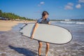 Surfer with his surfboard running to the waves