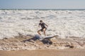 Surfer with his surfboard running to the waves Royalty Free Stock Photo