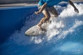 A Surfer On His White Board Surfing In The Wave Of A Swimming Pool