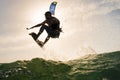 Surfer jumping in front of the sunset Royalty Free Stock Photo