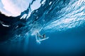 Surfer make duck dive underwater. Surfgirl dive under wave Royalty Free Stock Photo