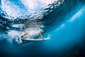 Surfer make duck dive underwater. Surfgirl dive under wave Royalty Free Stock Photo