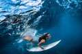 Surfer make duck dive underwater. Surfgirl dive under wave Royalty Free Stock Photo