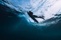 Surfer male with surfboard dive underwater with under big wave. Royalty Free Stock Photo