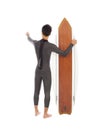 Surfer man holding a surfboard and point somewhere Royalty Free Stock Photo