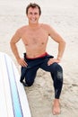 Surfer, man in portrait and beach with surfboard for ocean waves and fitness, adventure and travel for happiness. Nature Royalty Free Stock Photo