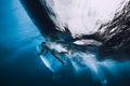 Surfer man with surfboard dive underwater. Alone surfer under big ocean wave. Royalty Free Stock Photo