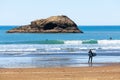 Surfer man walking on the wild beach. Landscape scenic view Oregon coast, USA