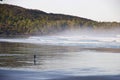 Surfer on misty Cox Bay, Tofino, British Columbia, Canada Royalty Free Stock Photo