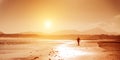 Surfer on the ocean beach at sunset on Canary Islands