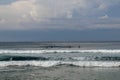 Surfer in the ocean waiting for a wave. Surfers waiting for good surfing waves. Surfers waiting for their wave. Young man waiting Royalty Free Stock Photo