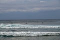 Surfer in the ocean waiting for a wave. Surfers waiting for good surfing waves. Surfers waiting for their wave. Young man waiting Royalty Free Stock Photo