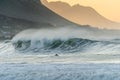 A surfer paddling out at Betty`s Bay beach at sunset in the Western Cape, South Africa Royalty Free Stock Photo