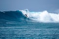 Surfer on perfect blue aquamarine wave, empty line up, perfect for surfing, clean water, Indian Ocean Royalty Free Stock Photo