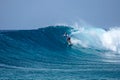 Surfer on perfect blue aquamarine wave, empty line up, perfect for surfing, clean water, Indian Ocean Royalty Free Stock Photo