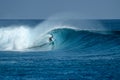 Surfer on perfect blue big tube wave, empty line up, perfect for surfing, clean water in Indian Ocean Royalty Free Stock Photo