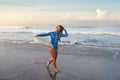 Surfer Portrait. Surfing Girl Carrying Surfboard. Smiling Brunette In Blue Wetsuit Walking On Ocean Beach At Sunset. Royalty Free Stock Photo