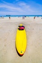 Surfer on Pretty beach and ocean with sailboat Royalty Free Stock Photo