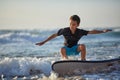 Surfer racing the curl of a sunlit blue-green wave