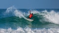 Surfer in Red shirt performing huge cutback and great spray, action in Redbull championship.