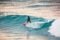 Surfer ride on red surfboard on blue wave. Winter surfing in ocean Royalty Free Stock Photo