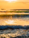 Surfer ride on wave with warm tones of sunset. Surfing in ocean at wave