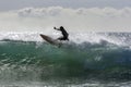 A surfer rides a point break wave at Arugam Bay in Sri Lanka.