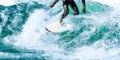 Surfer rides on turquoise ocean wave