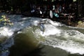 A surfer rides the wave that takes shape in the stream of the Englischer Garten or English Garden in Munich.