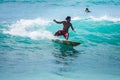 Surfer rides the waves. Dreamland Beach. Bali