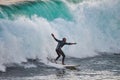 Surfer riding a 10 foot wave