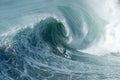 Surfer riding forward the moving foamy wave of the Atlantic Ocean at Nazare, Portugal