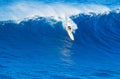 Surfer riding giant wave