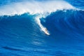 Surfer riding giant wave